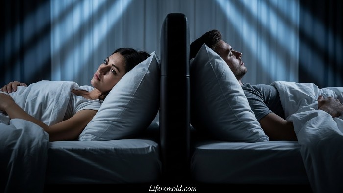 Couple sleeping apart in bed displaying emotional disconnection and relationship problems