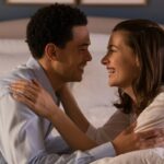 A happy couple connecting intimately in their bedroom at night.