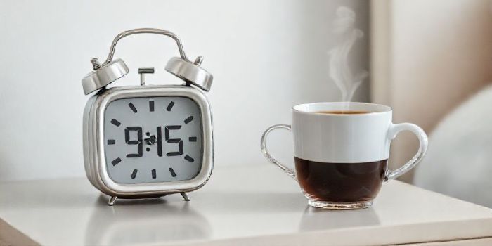  A cup of coffee next to a clock showing the strategic time to drink it for better energy.