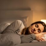 Peaceful woman sleeping instantly using 5-minute relaxation technique in comfortable bedroom