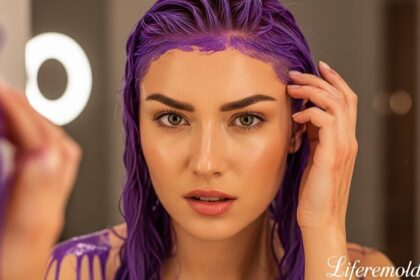 Beautiful woman with purple hair dye stains on skin looking at camera showing how to get hair dye off skin
